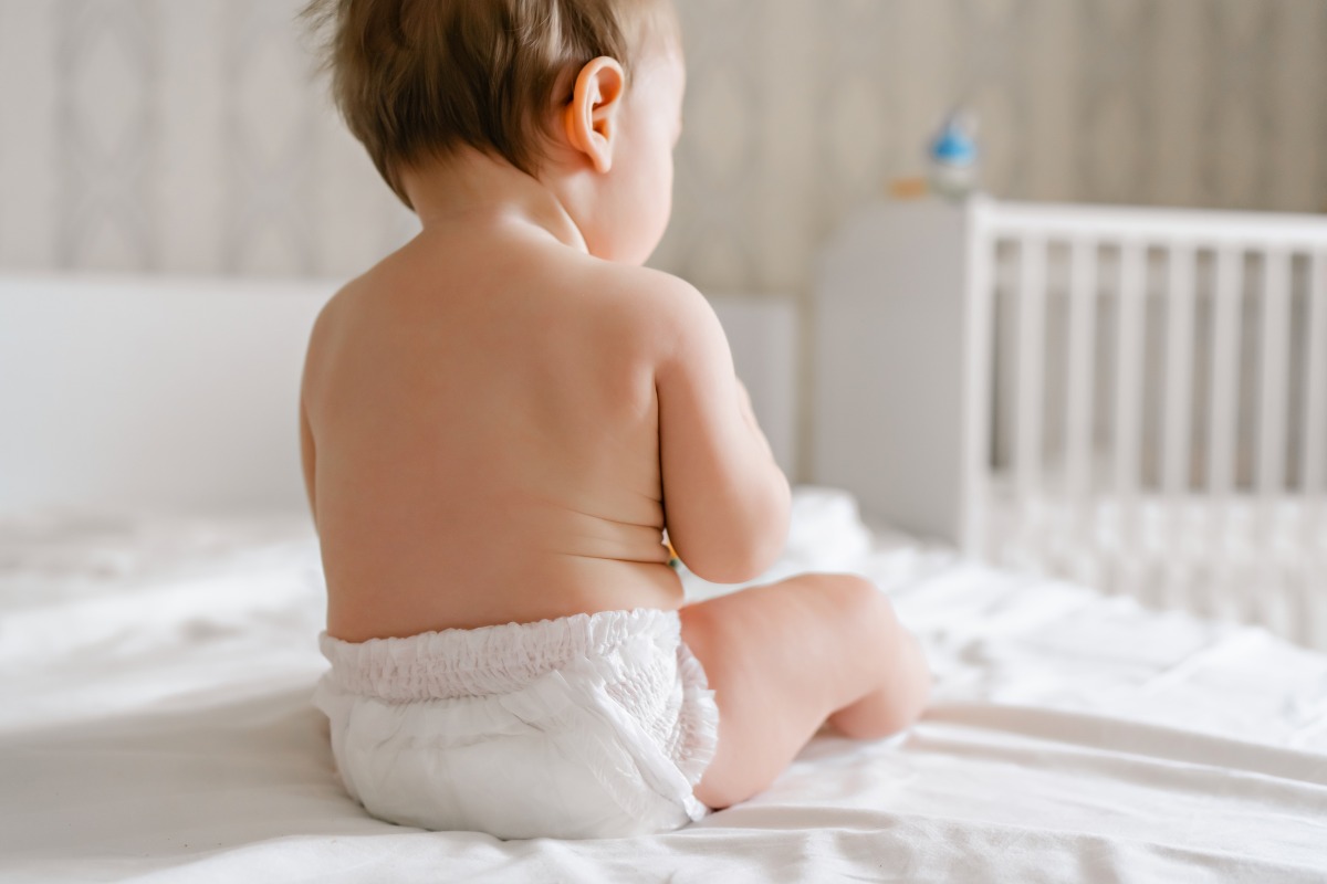cute baby dry soft diaper white bed home back view high quality photo